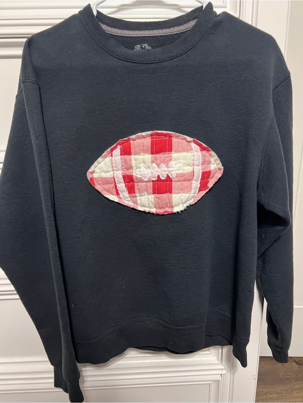 Women’s Black Crewneck Sweatshirt with Red Plaid Patch